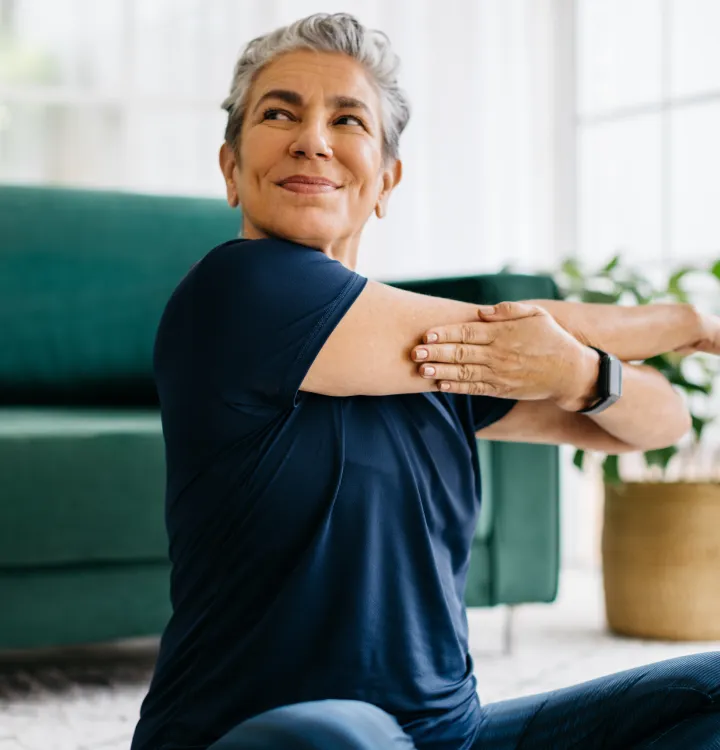 A woman stretching her shoulder